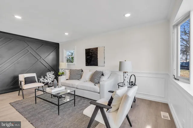 a kitchen with stainless steel appliances kitchen island granite countertop a stove a sink island and a refrigerator with wooden floor