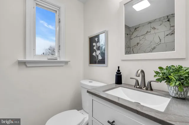 an empty room with wooden floor and window