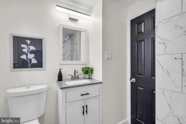 a view of an empty room with a painting on the wall