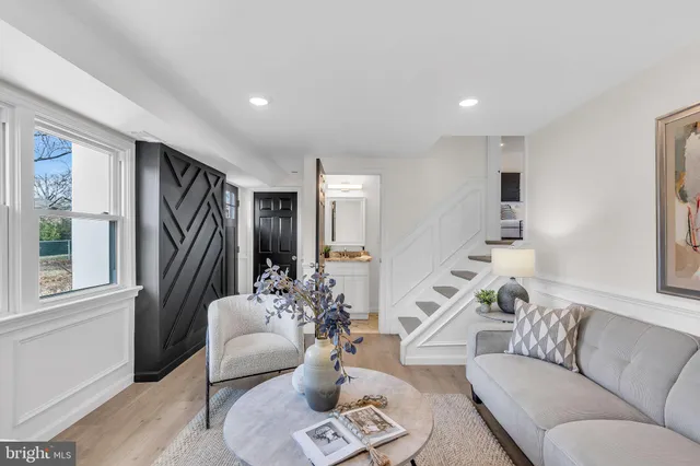 a bathroom with a granite countertop sink vanity mirror and toilet