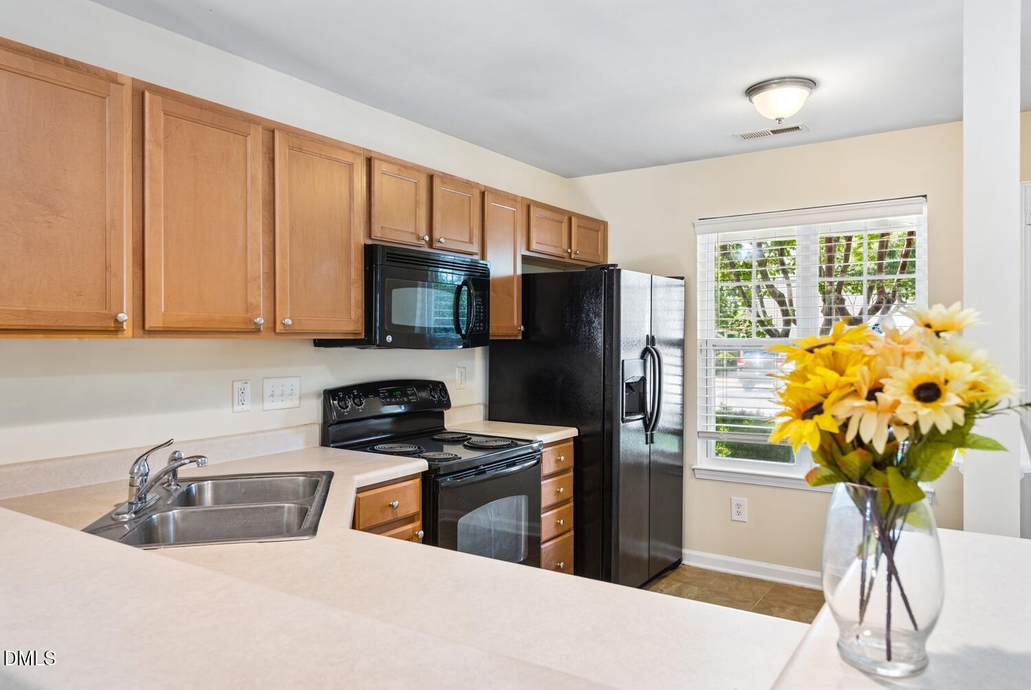 3635 Bison Hill Lane Raleigh, NC 27604 - Photo 6 of 18 a kitchen with stainless steel appliances granite countertop a refrigerator a sink a stove a counter space and cabinets