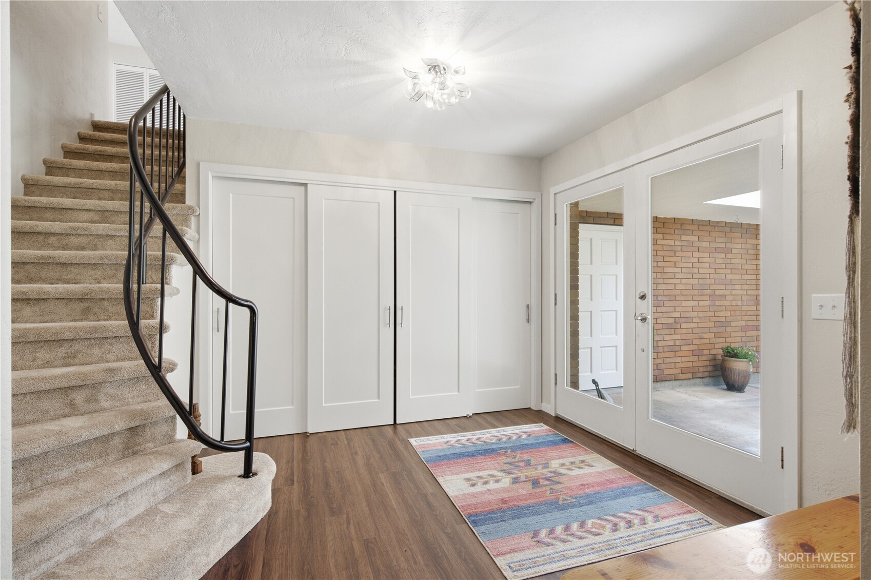 3050 Southeast Mullenix Road Port Orchard, WA 98367 - Photo 4 of 40 a view of a hallway with wooden floor and stairs