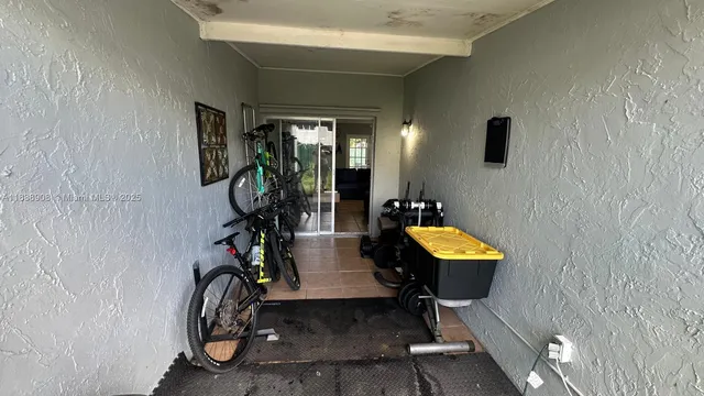 a view of living room with patio furniture and potted plants