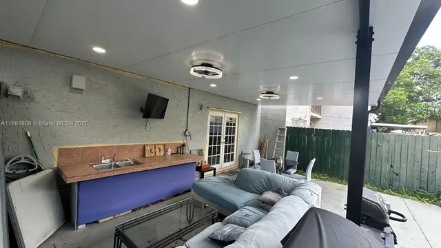 a view of a hallway with workspace and a window