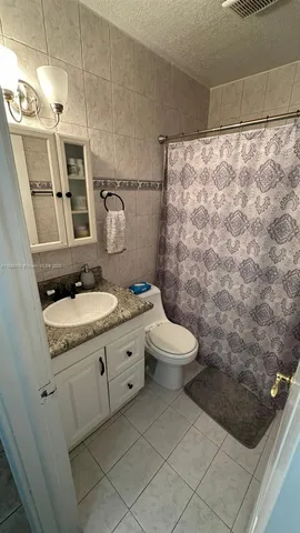 a living room with a bed and a window