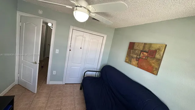 a bedroom with furniture and a flat screen tv