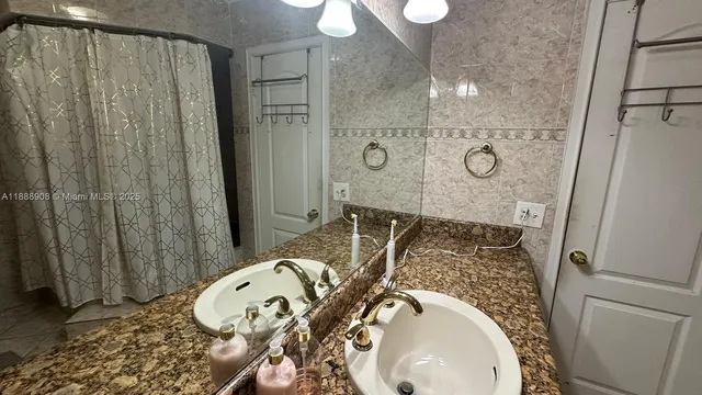 en empty room with windows and chandelier fan