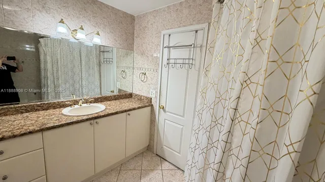 a bathroom with a toilet mirror and sink