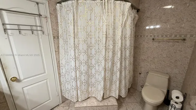 a bathroom with a glass door shower and a mirror