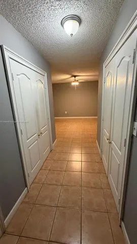 a view of hallway with a window and stairs