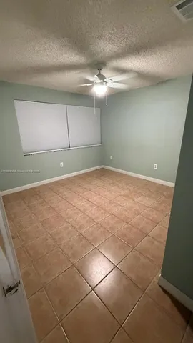 a kitchen with granite countertop kitchen island stainless steel appliances a sink stove and cabinets