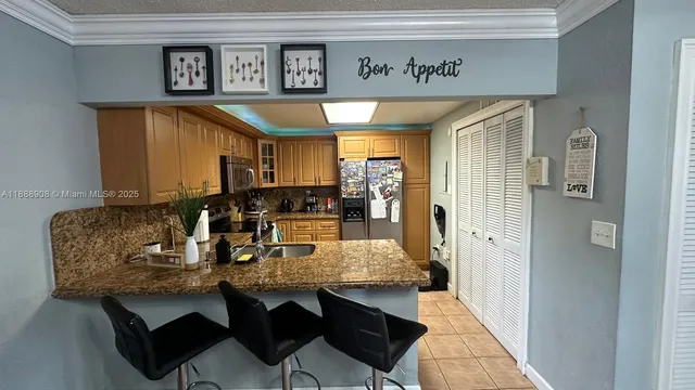 a kitchen with stainless steel appliances granite countertop a stove microwave and sink