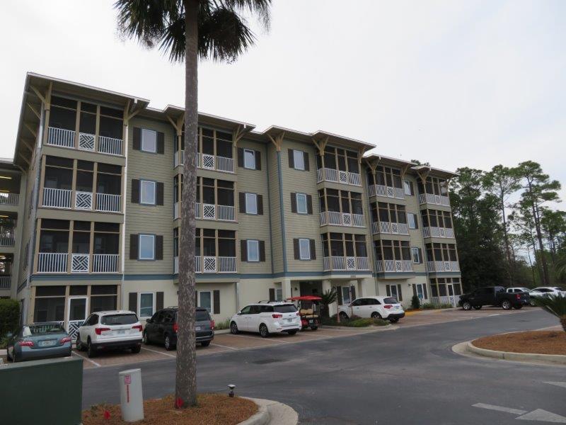 231 Somerset Bridge Road, Unit 2401 Santa Rosa Beach, FL 32459 - Photo 19 of 22 a front view of a building with lot of cars and trees