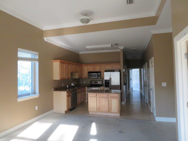 231 Somerset Bridge Road, Unit 2401 Santa Rosa Beach, FL 32459 - Photo 5 of 22 a kitchen with stainless steel appliances kitchen island granite countertop a refrigerator a sink a stove a microwave and wooden cabinets