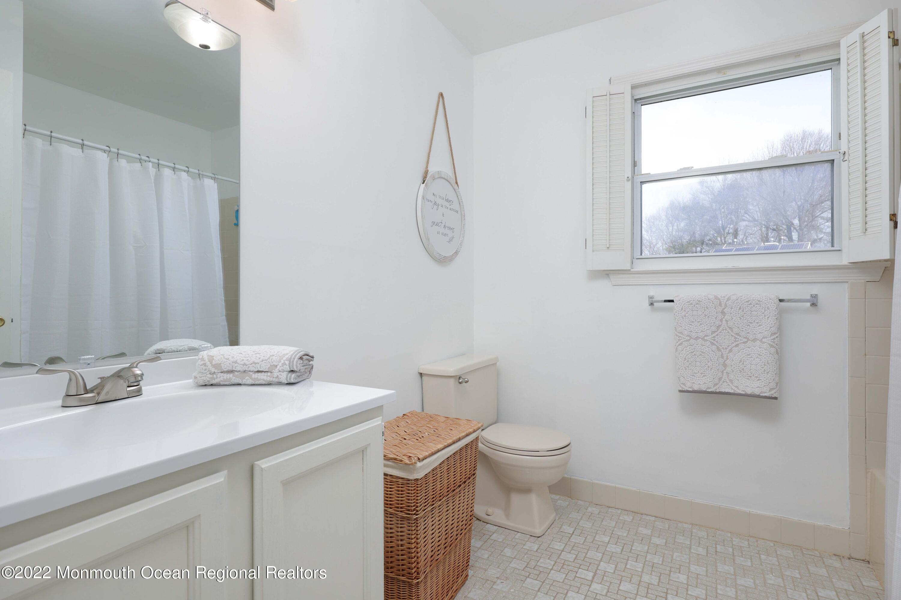 8 Reed Road Howell, NJ 07731 - Photo 15 of 22 a bathroom with a sink toilet and vanity