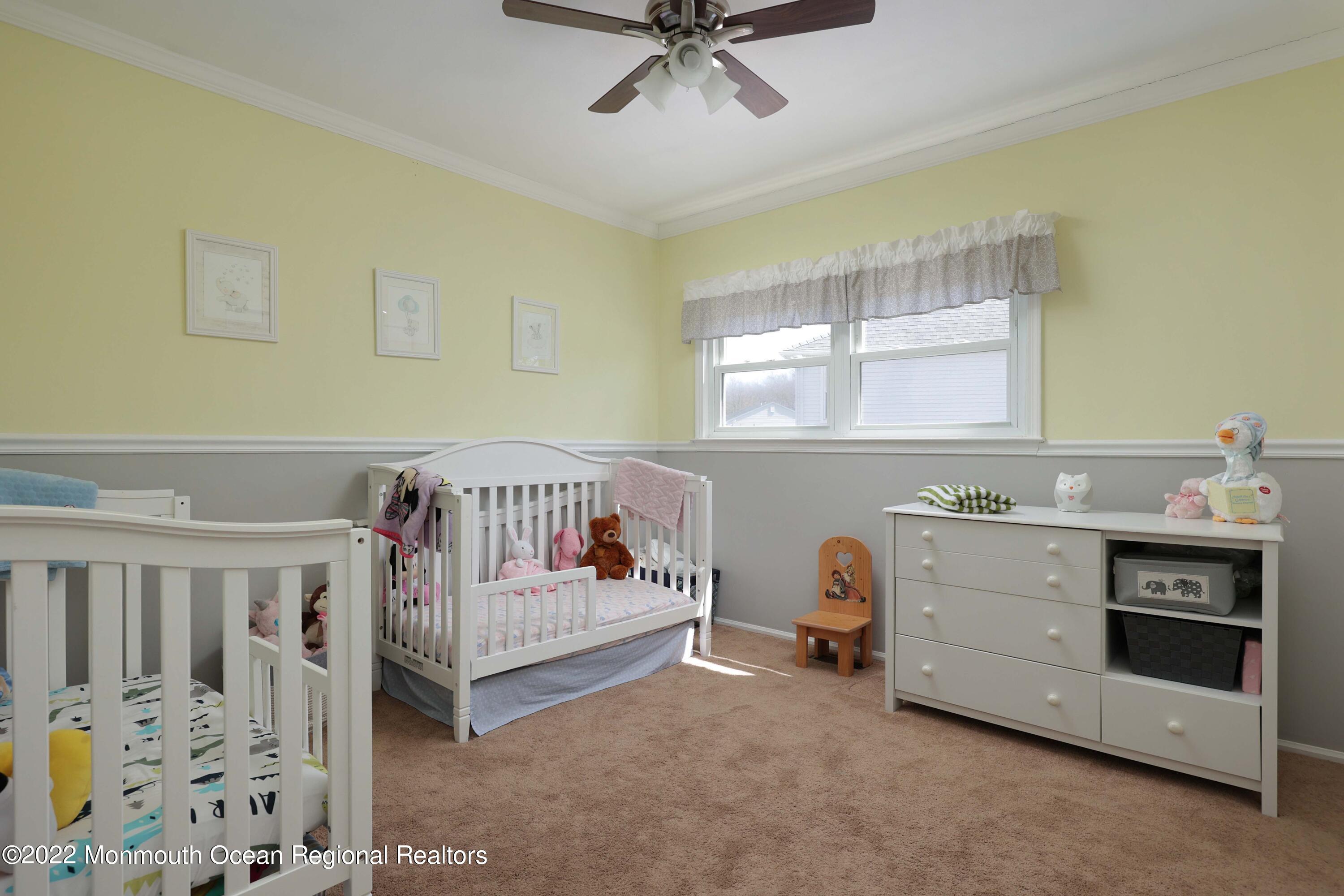8 Reed Road Howell, NJ 07731 - Photo 17 of 22 a view of a bedroom with baby crib and a window