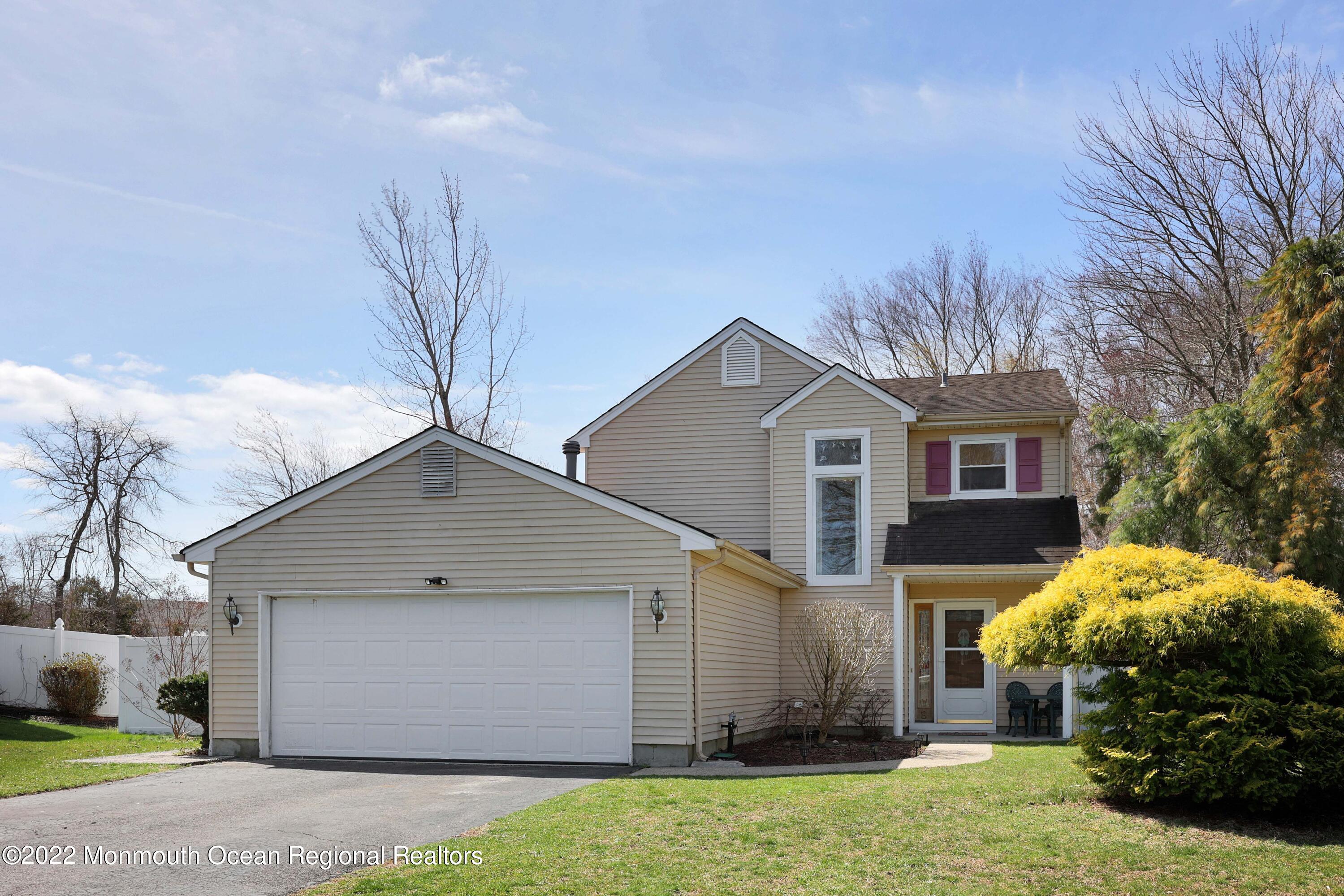 8 Reed Road Howell, NJ 07731 - Photo 2 of 22 a front view of house with yard and trees around
