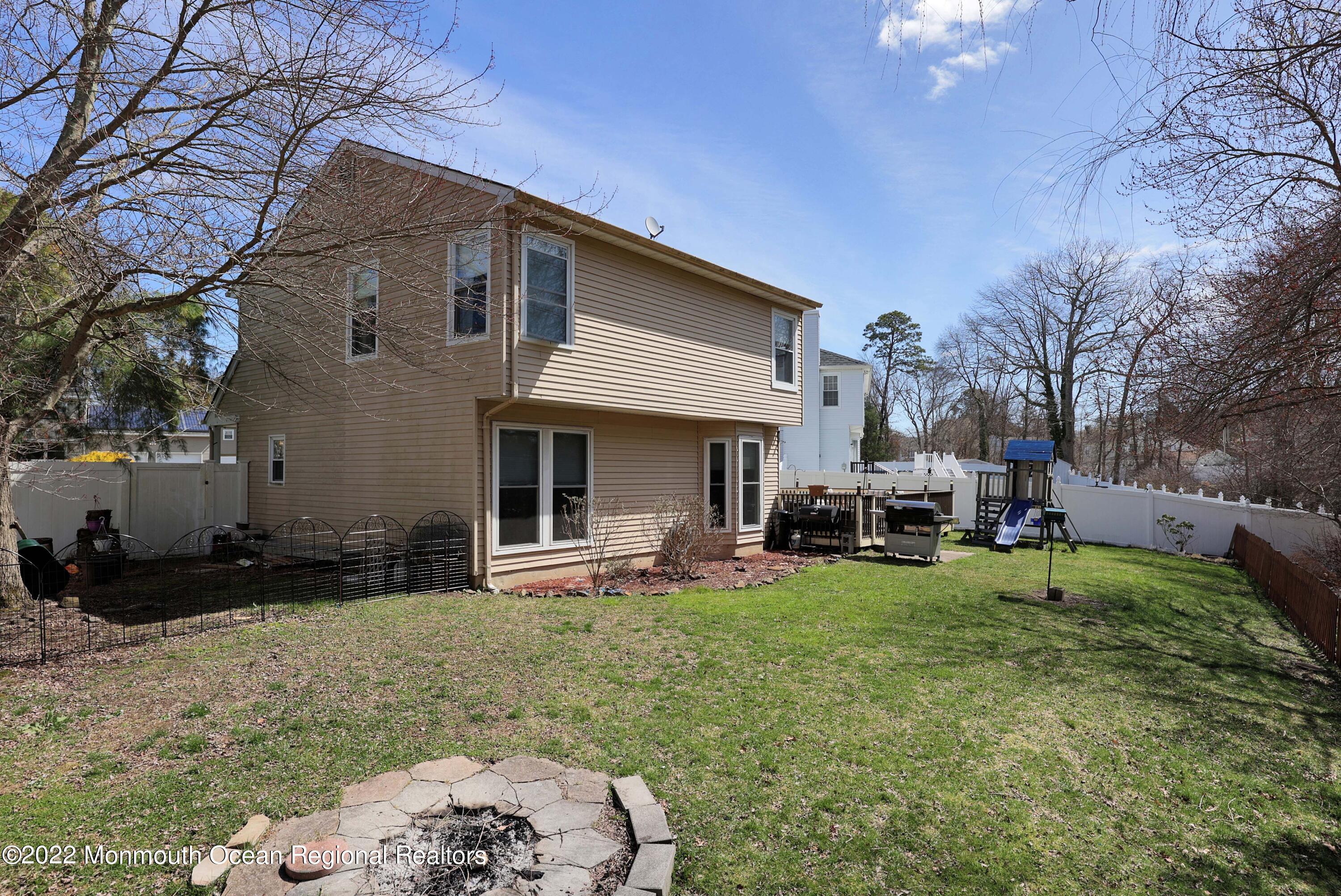 8 Reed Road Howell, NJ 07731 - Photo 21 of 22 a view of a house with backyard porch and sitting area