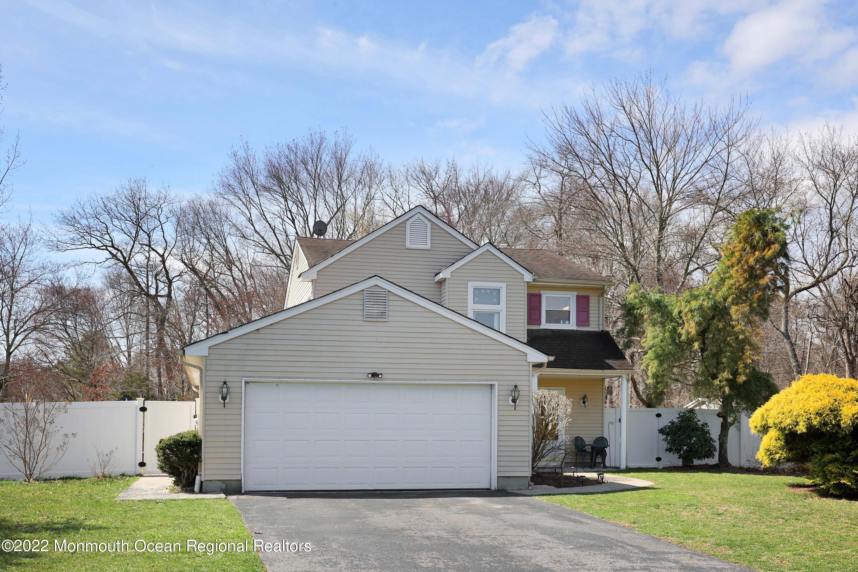 8 Reed Road Howell, NJ 07731 - Photo 3 of 22 a front view of house with yard and trees all around