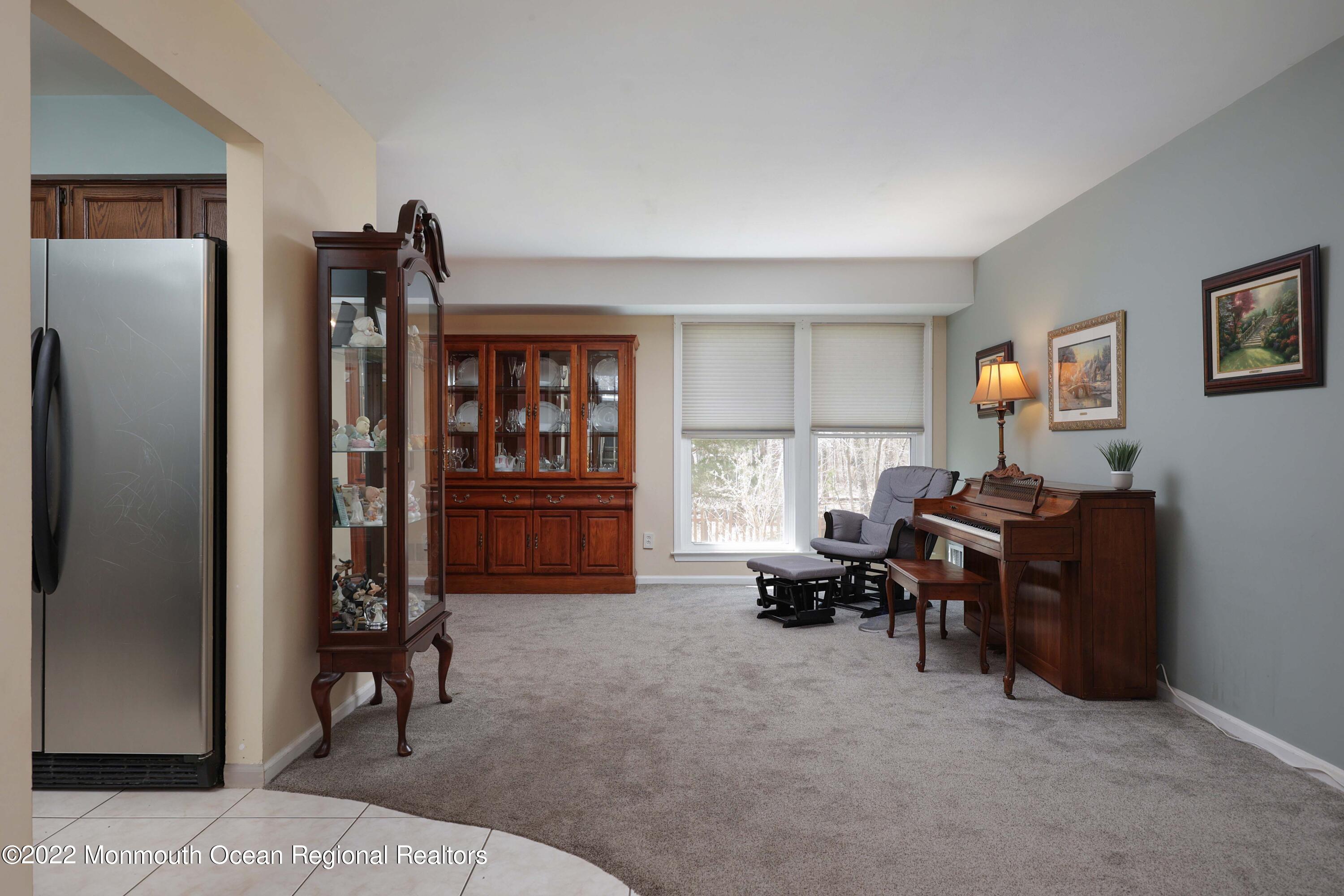 8 Reed Road Howell, NJ 07731 - Photo 6 of 22 a living room with furniture a window and a piano