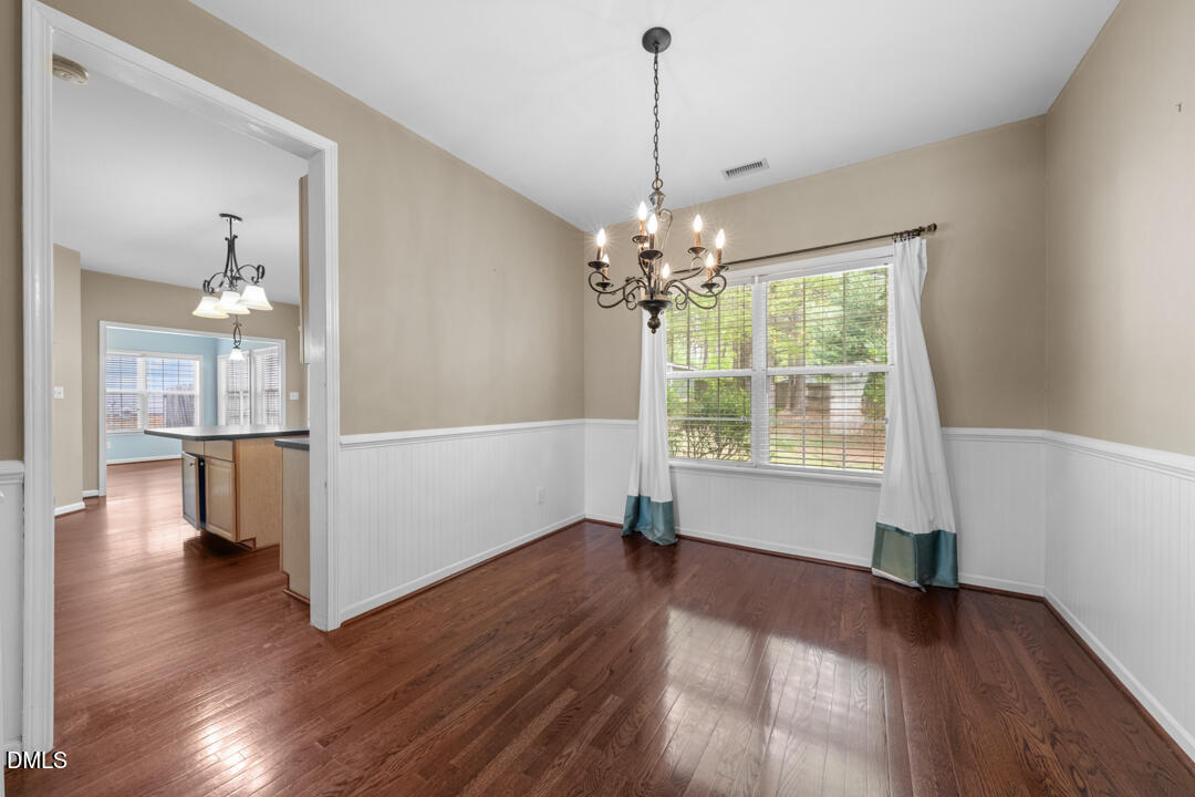 5324 Bartram Place Raleigh, NC 27617 - Photo 10 of 35 a view of an empty room with wooden floor and a window