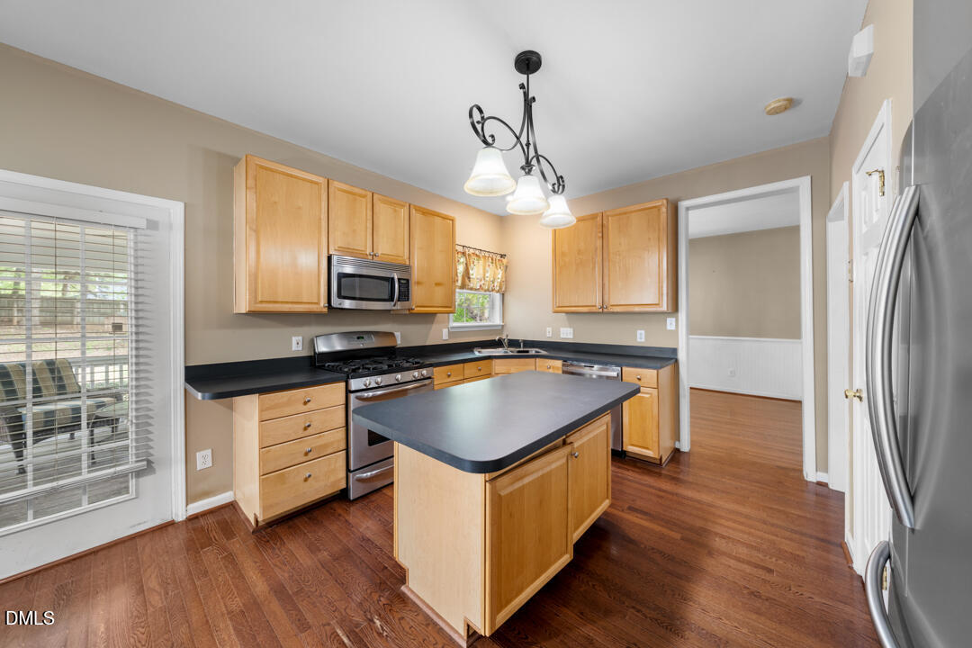 5324 Bartram Place Raleigh, NC 27617 - Photo 13 of 35 a kitchen with stainless steel appliances granite countertop a stove a sink dishwasher a refrigerator and a microwave oven with wooden floor