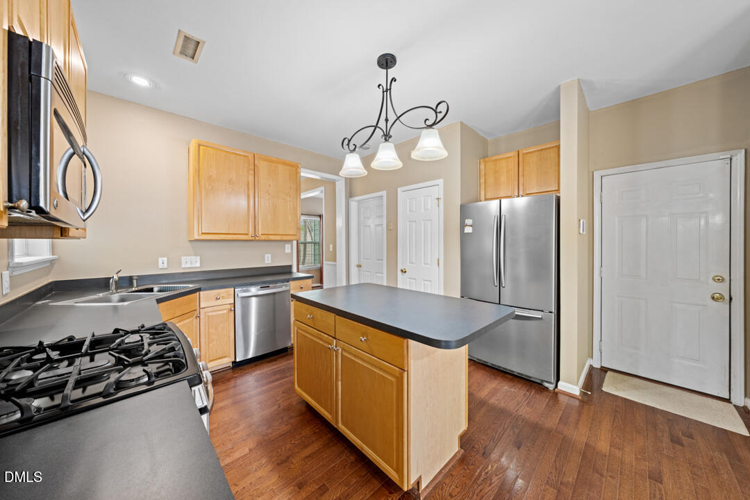 5324 Bartram Place Raleigh, NC 27617 - Photo 14 of 35 a kitchen with a refrigerator and a sink