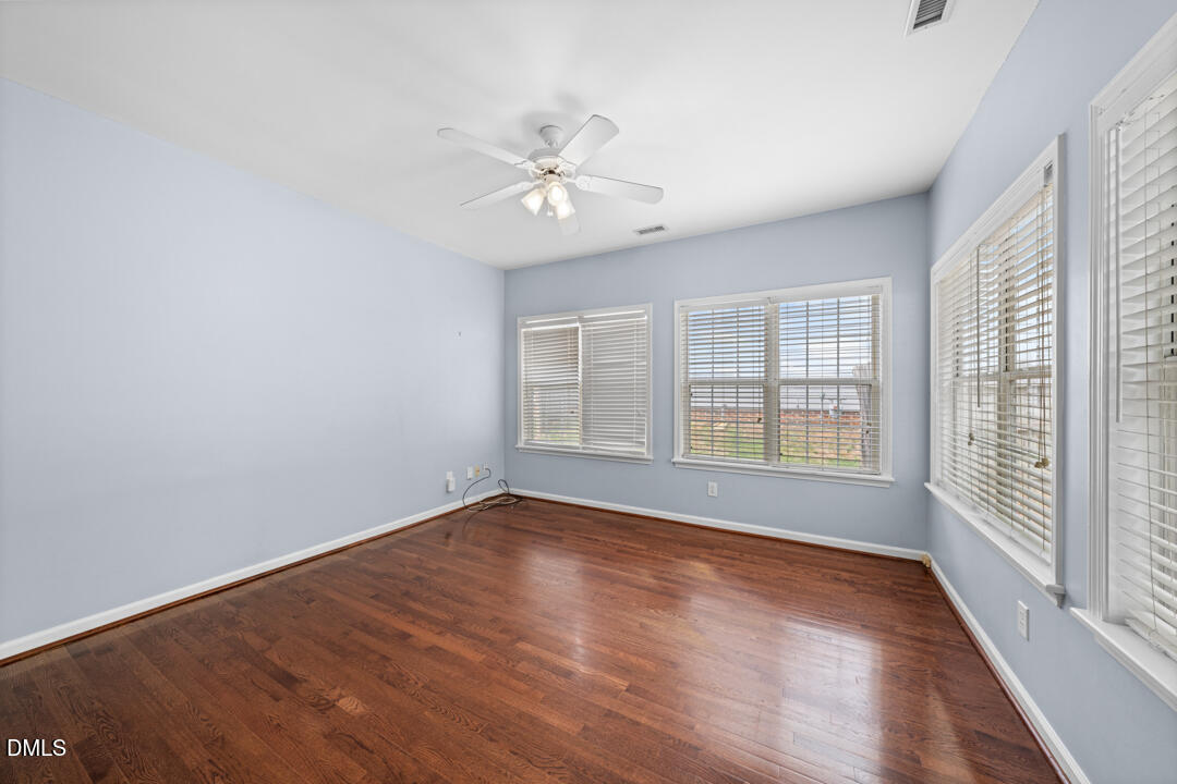 5324 Bartram Place Raleigh, NC 27617 - Photo 17 of 35 a view of an empty room with wooden floor and a window