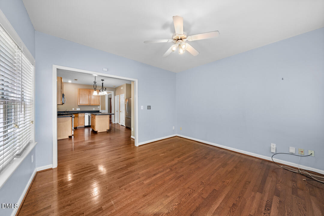 5324 Bartram Place Raleigh, NC 27617 - Photo 18 of 35 wooden floor in an empty room with a window