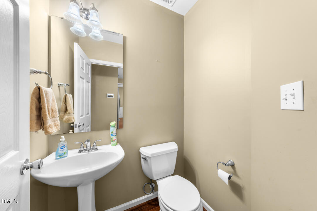 5324 Bartram Place Raleigh, NC 27617 - Photo 19 of 35 a bathroom with a toilet sink and mirror