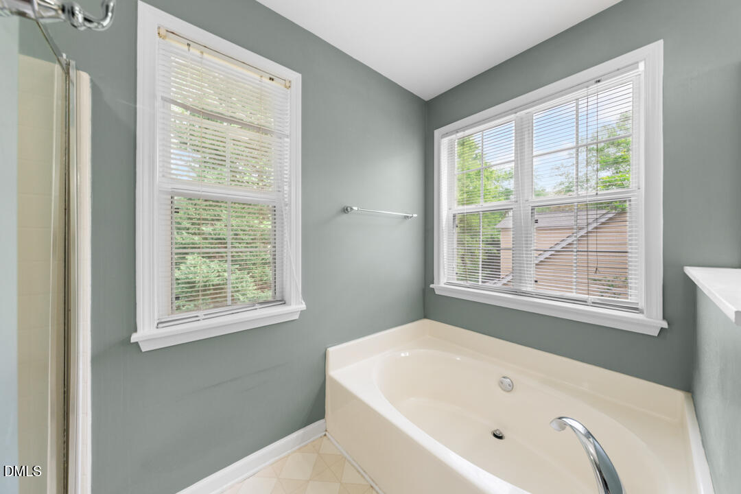 5324 Bartram Place Raleigh, NC 27617 - Photo 22 of 35 a white bath tub sitting in a bathroom next to a window