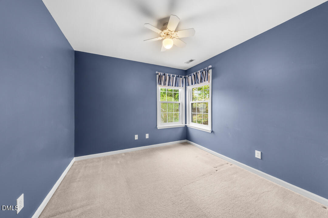 5324 Bartram Place Raleigh, NC 27617 - Photo 23 of 35 an empty room with windows and ceiling fan