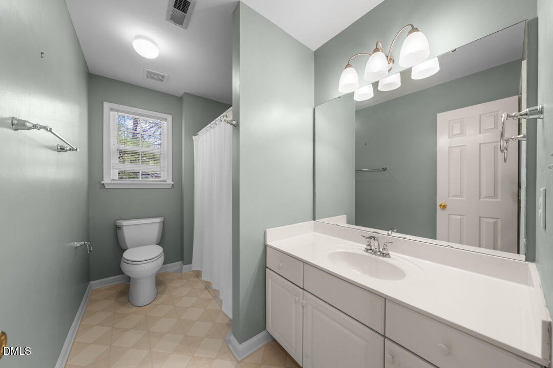 5324 Bartram Place Raleigh, NC 27617 - Photo 25 of 35 a bathroom with a toilet sink and mirror