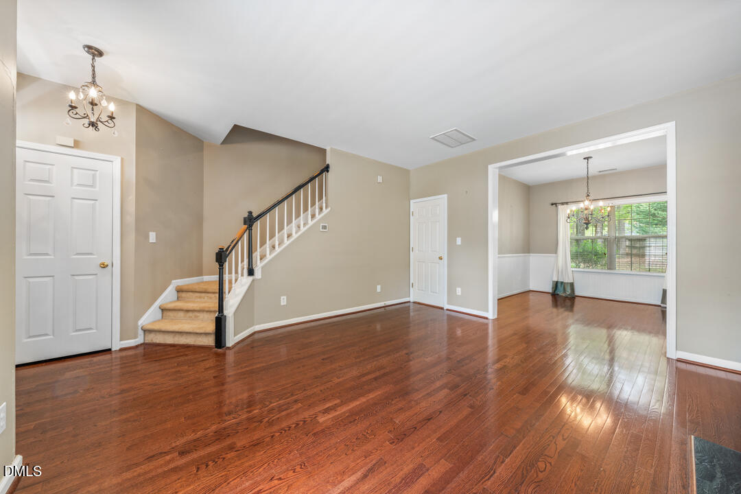 5324 Bartram Place Raleigh, NC 27617 - Photo 6 of 35 a view of empty room with wooden floor and fan