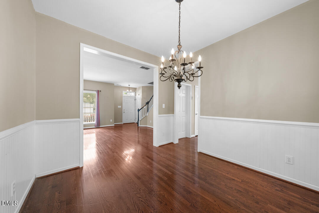 5324 Bartram Place Raleigh, NC 27617 - Photo 9 of 35 a view of a room with wooden floor chandelier and windows