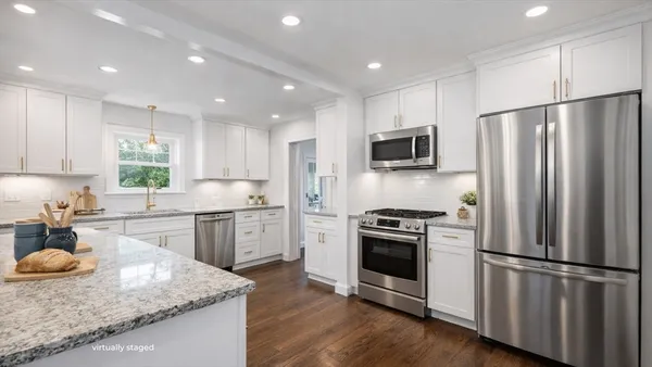 a kitchen with a refrigerator stove microwave and sink