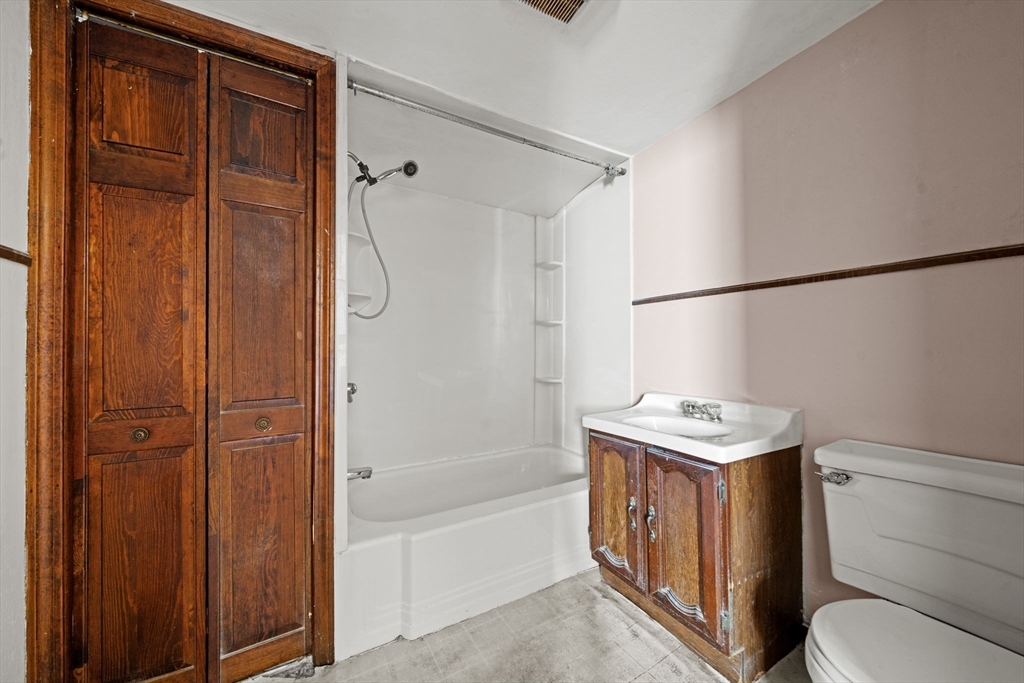 6 Cottage Street Lowell, MA 01852 - Photo 15 of 32 a bathroom with a toilet sink and shower