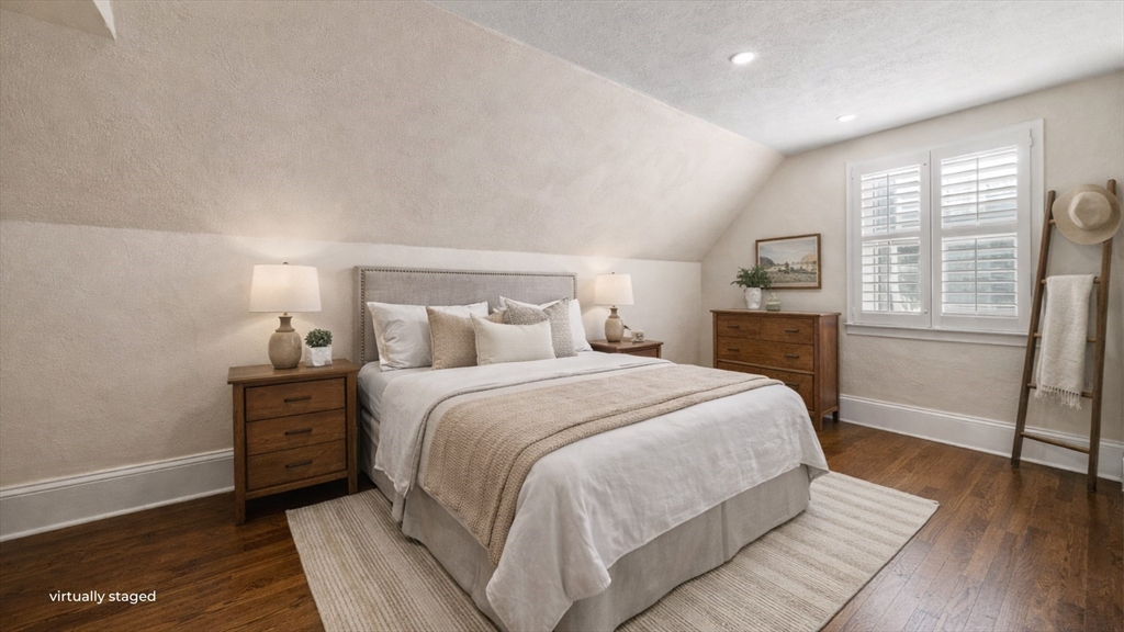 6 Cottage Street Lowell, MA 01852 - Photo 20 of 32 a bedroom with a bed and wooden floor