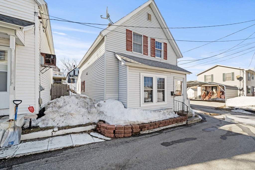 6 Cottage Street Lowell, MA 01852 - Photo 2 of 32 a front view of a house with a yard
