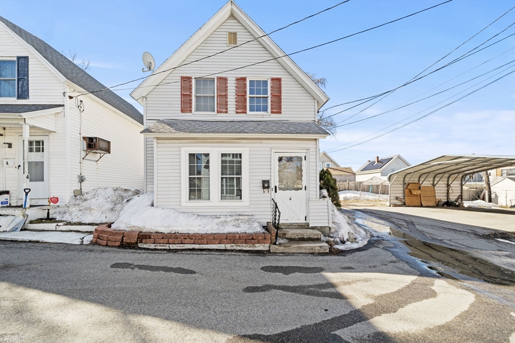 6 Cottage Street Lowell, MA 01852 - Photo 28 of 32 a front view of a house with a yard