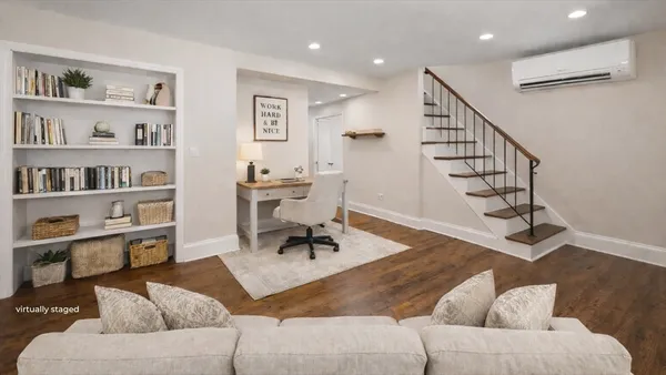 a living room with furniture and a book shelf