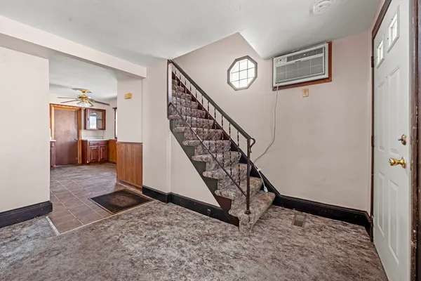 a view of a hallway with stairs