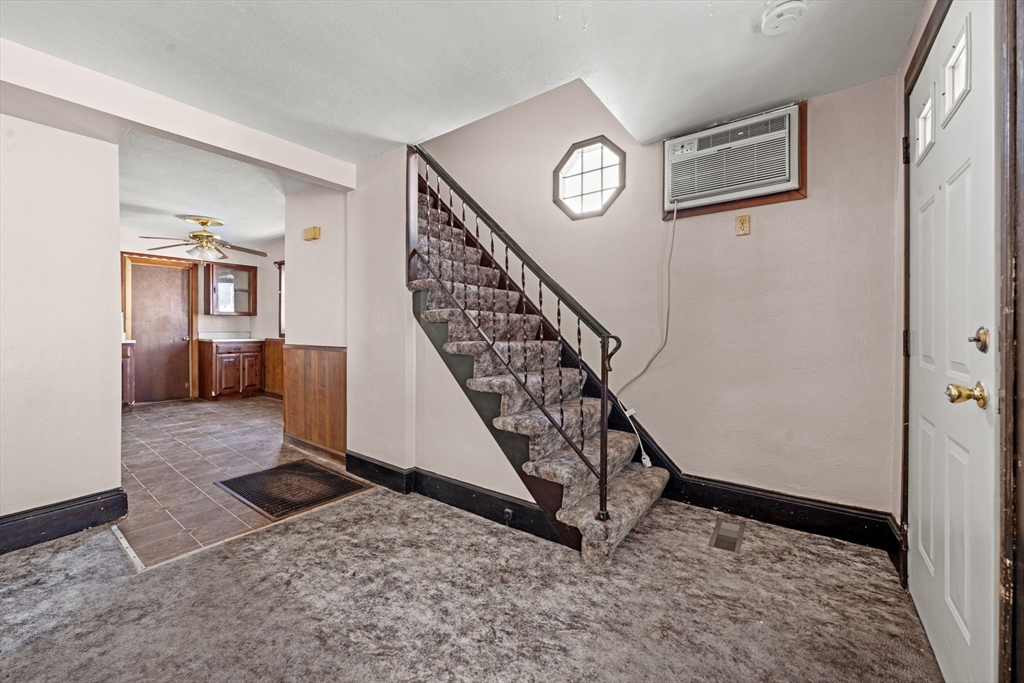 6 Cottage Street Lowell, MA 01852 - Photo 8 of 32 a view of a hallway with stairs