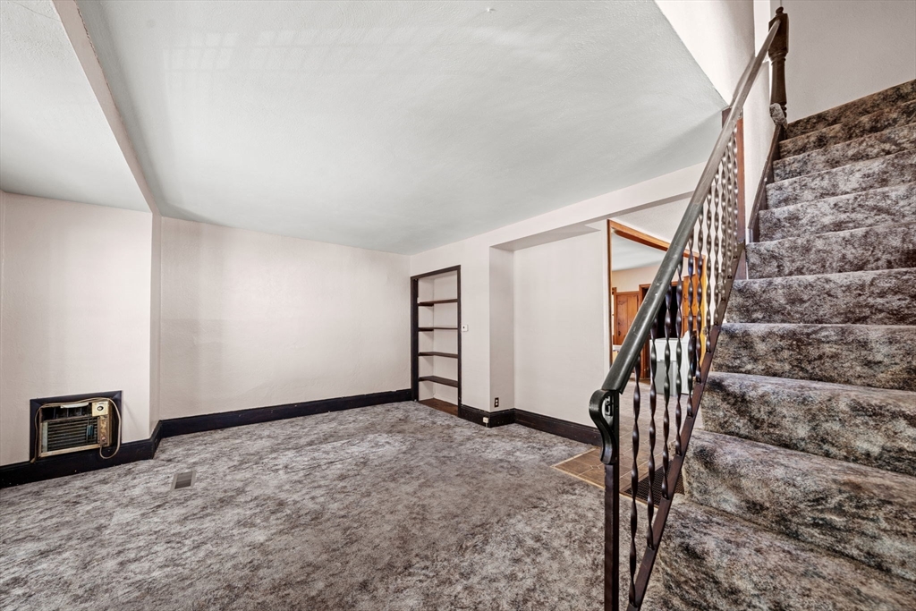 6 Cottage Street Lowell, MA 01852 - Photo 9 of 32 a view of an empty room with stairs