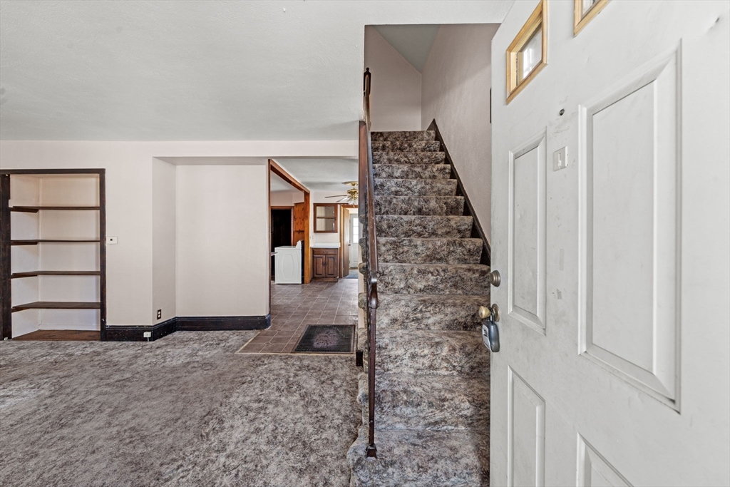 6 Cottage Street Lowell, MA 01852 - Photo 10 of 32 a view of a livingroom with wooden floor and stairs