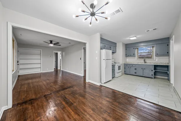 a view of a kitchen with a sink and a refrigerator