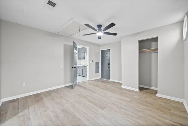 a view of empty room with wooden floor