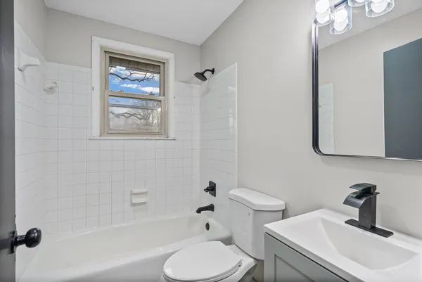 a bathroom with a sink toilet a mirror and shower