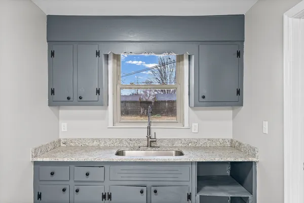 a kitchen with a sink a cabinets and window