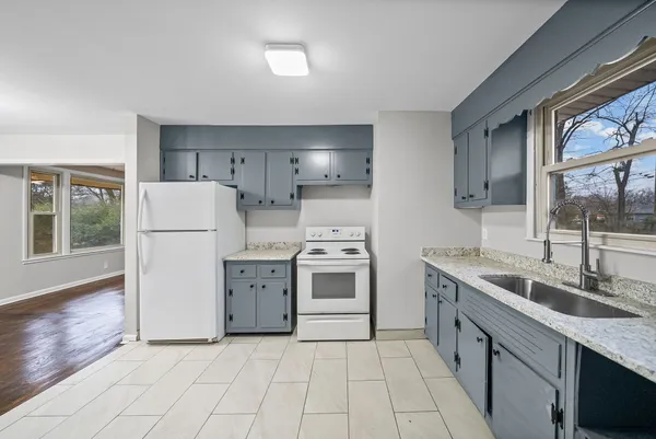 a kitchen with a stove a sink and a refrigerator